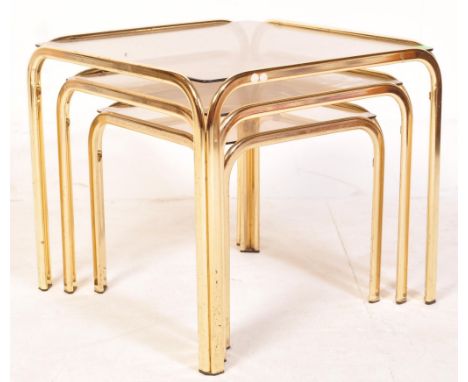 A vintage retro 20th century Hollywood Regency style nest of tables, each having a brass tubular frame with glaze top. Measur