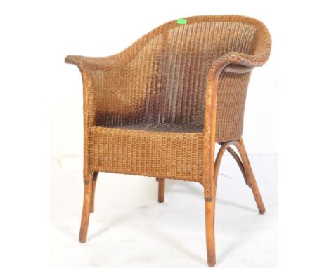 A retro vintage mid 20th Century Lloyd Loom tub chair with W. Lusty &amp; Sons label. The chair having a domed shaped back wi