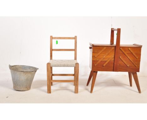 A retro vintage mid 20th century teak metamorphic sewing box raised over tapering supports. Together with a miniature wicker 