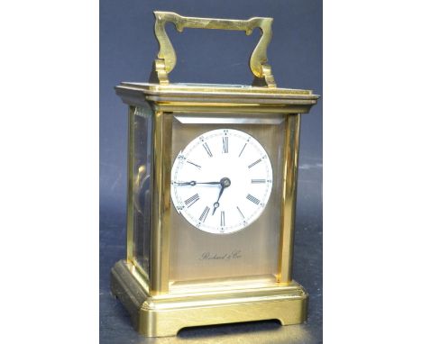 A 20th century Richard &amp; Cie brass carriage clock. White circular dial with roman numeral chapter ring. The brass movemen