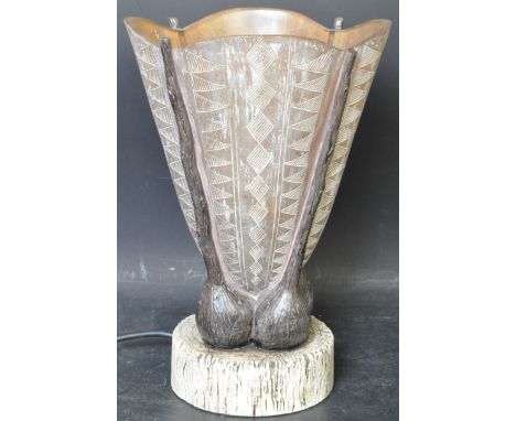 A vintage 20th Century etched resin table lamp of shell form with geometric etched patterned decoration with all raised on a 