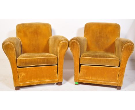 A pair of vintage 1940's velvet club armchairs. The chairs having mustard/yellow velvet material, flared arm rest, with one h
