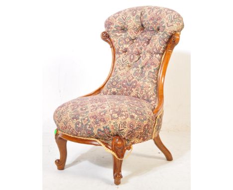 A Victorian 19th century nursing chair being raised on cabriole legs with hoof feet and castors. Show wood frame with button 