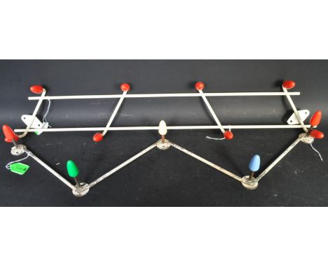 A pair of vintage retro mid 20th century Atomic sputnik style coat racks of zig zag format with plastic multicolour hooks. Me