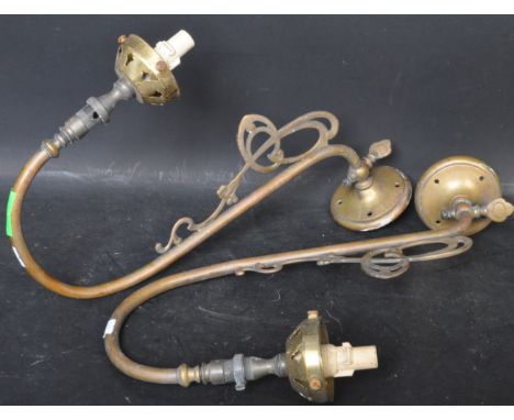 A pair of vintage 20th century Art Nouveau style wall mounted sconce brass lights. The lights having a curved chandelier arm 