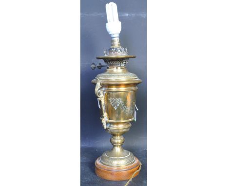 An early 20th century brass table lamp comprising of a Wright &amp; Butler oil lamp conversion with decorative twin handles o