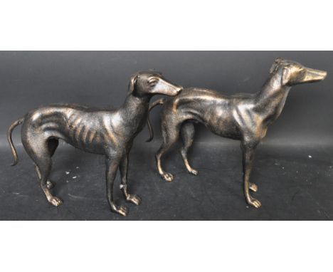 A pair of vintage style cast metal greyhound figures posing in a standing position. Measures 30cm high x 40cm long,