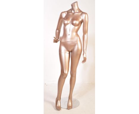 A retro vintage 20th century circa 1970s haberdashery plastic metallic female mannequin with foot stand. It comes in two part