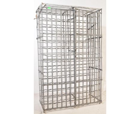 A large retro vintage 20th Century industrial metal wired wall mounted bottle/wine rack. The bottle holder is painted black, 