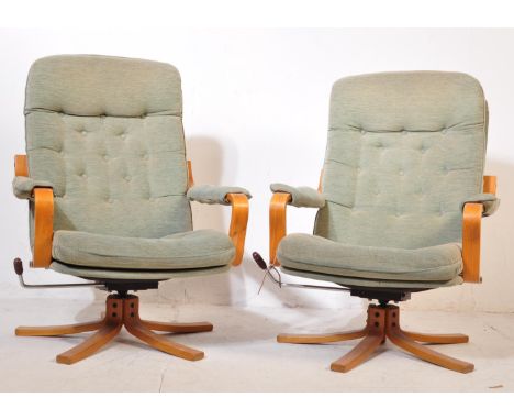 A pair of two Bentwood Moran mid 20th Century circa 1970's upholstered swivel/lounge chairs (AF). The chairs having a button 
