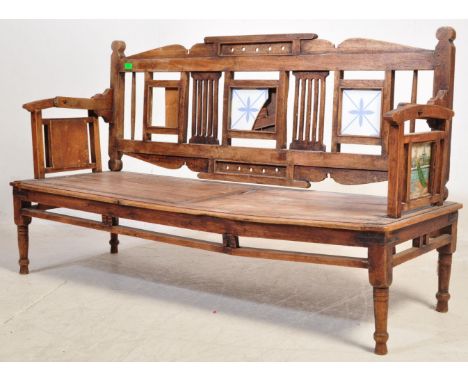 A vintage Indian teak bench. With a reversible / rotating back rest. With three tile section to the backrest and Asian tiles 