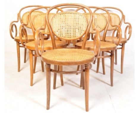 A collection of six vintage 20th century Thonet style dining chairs having a curved backrest, rattan back and seat flanked by