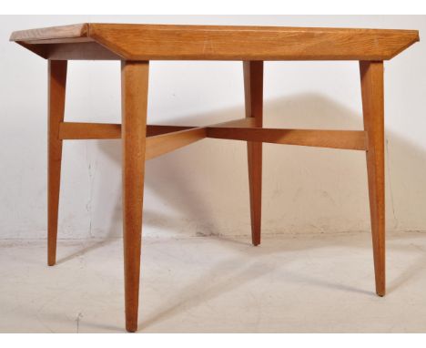 A retro vintage circa 1950's oak extending dining table with a set of four chairs. The light oak dining table having a rectan