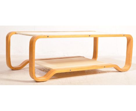 A retro vintage circa 1960's bentwood coffee table. The table having a rectangular top with a under tier table with shaped le