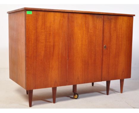 A retro vintage mid 20th century teak wood metamorphic desk writing cabinet in the manner of NewCraft. The desk opening to re