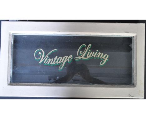 A retro vintage mid 20th Century wooden framed shop window / hanging glass sign having a painted cream frame with stencilled 