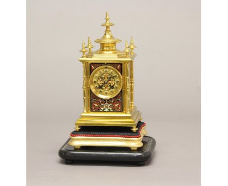 A VICTORIAN GILT BRASS AND ENAMEL MANTEL CLOCK. The dial with Roman numerals and central foliate gilt metal mount, with an ei