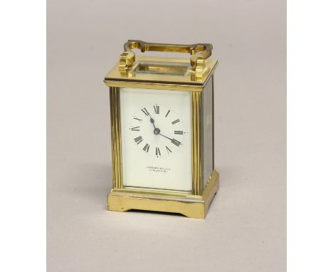 A BRASS CASED CARRIAGE CLOCK BY GARRARD OF LONDON. A brass cased carriage clock with rectangular white enamelled dial with Ro