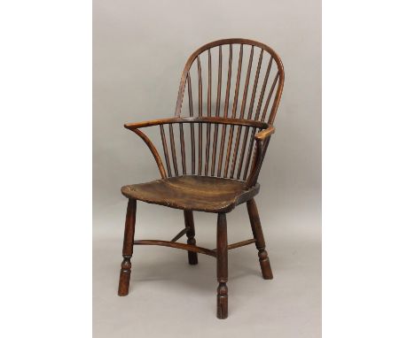 A YEW AND ELM WINDSOR CHAIR, the comb back above solid seat, turned legs and crinoline stretcher, height 101cm