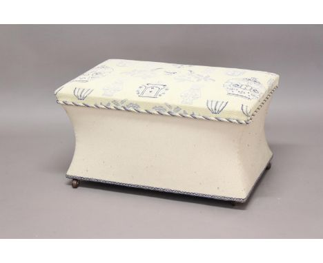 A VICTORIAN STYLE UPHOLSTERED BOX OTTOMAN. The rectangular box ottoman upholstered in blue and white fabric, with concave sid