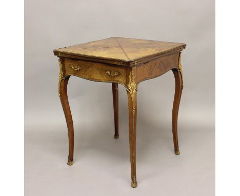 A LATE 19TH CENTURY ROSEWOOD ENVELOPE CARD TABLE, with marquetry musical instrument inlay and ormolu mounts on slender cabrio