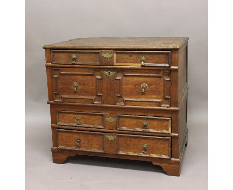 AN OAK CHEST OF DRAWERS, late 17th/early 18th century, with four panelled long drawers on bracket feet, in two parts, height 