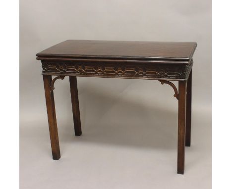 A GEORGE III MAHOGANY CARD TABLE. With a rectangular fold top with moulded border and baize lined interior, above a blind-fre