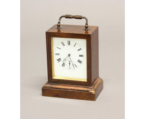 A 19TH CENTURY FRENCH ROSEWOOD CASED TRAVELLING CLOCK. The rectangular white enamelled dial with Roman numerals and subsidiar