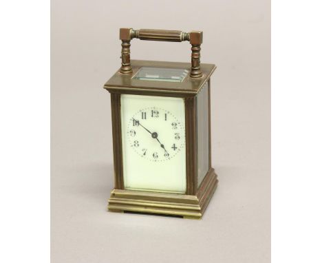 A VICTORIAN BRASS CASED CARRIAGE CLOCK. A brass cased carriage clock with ivory effect enamelled dial, the case with moulded 