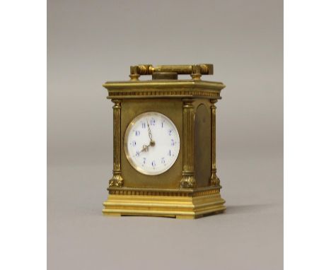 A MINIATURE FRENCH BRASS CASED CARRIAGE CLOCK. A miniature French Carriage clock with a circular enamelled dial with blue ena