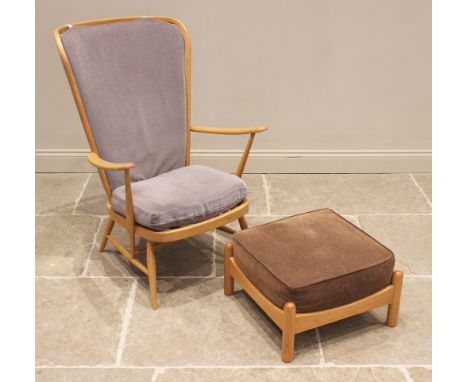 An Ercol beech stick back wing armchair, mid 20th century, the shaped wing backs extending to down swept arms enclosing the b