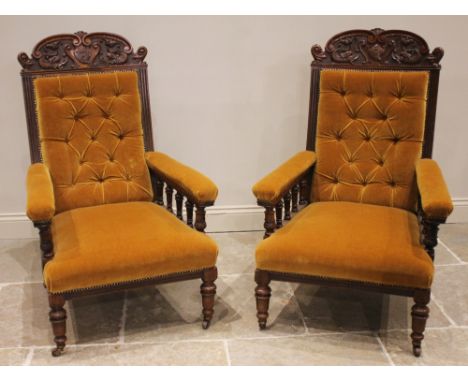 A pair of Victorian carved walnut open armchairs, probably by S J Waring &amp; Sons, Liverpool, the shaped top rails with 'C'