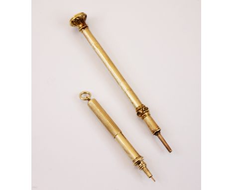 A yellow metal propelling toothpick, the engine turned detailed body with plain polished pendant bale, 7cm long (extended) wi