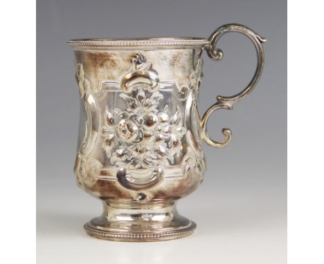 A Victorian silver christening mug, Henry Wilkinson and Co, London 1867, the beaded rim above an embossed floral body, upon c