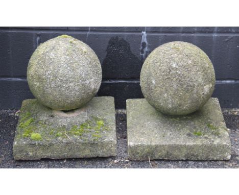 A pair of reconstituted stone gate post finials, of sphere form upon integral square plinths, 42cm H x 40cm Sq (2) 