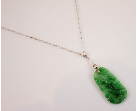 An Art Deco jade and diamond necklace, the pearl and old cut diamond mounted white metal spacer suspending a carved jade pane