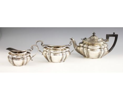 A silver tea service, Josiah Williams and Co, London 1900-1901, comprising teapot, milk jug and sugar bowl, of lobed form wit