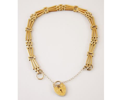 A yellow metal gate link bracelet, designed as fancy gate link sections interspersed with brick link sections, stamped 'DRT' 