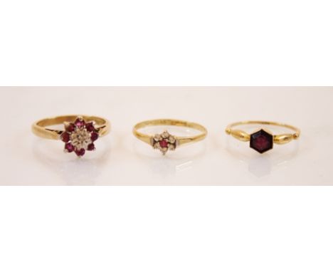 A ruby and diamond 9ct gold cluster ring, the central raised illusion set diamond chip within a surround of round cut ruby st