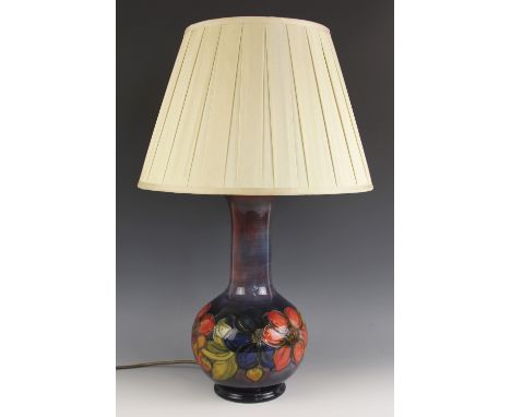 A Moorcroft table lamp in the "Clematis" pattern against a cobalt blue ground, impressed makers marks and painted Walter Moor