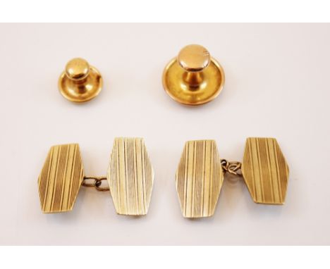 A pair of yellow metal cufflinks, each link of flattened hexagonal form with engine turned decoration, 18mm long, with curb l