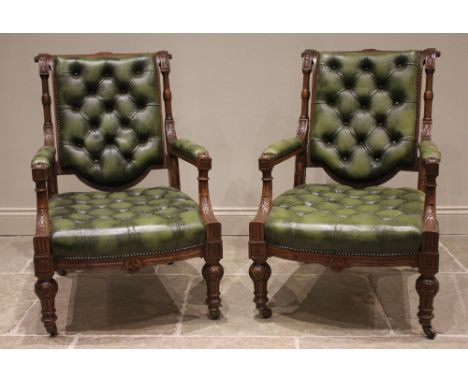 A pair of Victorian oak and olive green leather library chairs, in the manner of Holland &amp; Sons, the fluted top rail and 