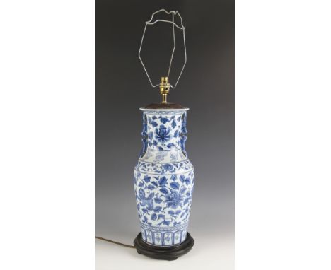 A Chinese porcelain blue and white lamp base, 20th century, the baluster shaped vase decorated with floral sprays, and zoomor