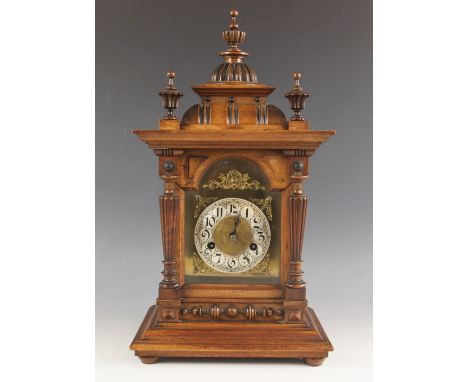 A walnut cased German eight day mantel clock by H.A.C ( Hamburg America Clock Co), late 19th century, the architectural case 