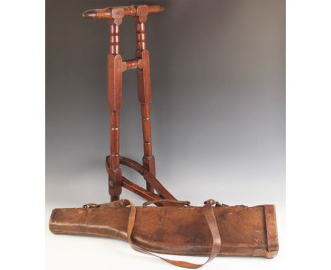 A Victorian mahogany boot jack, late 19th century, of typical form with bobbin turned details, 80cm high, with a leather leg 