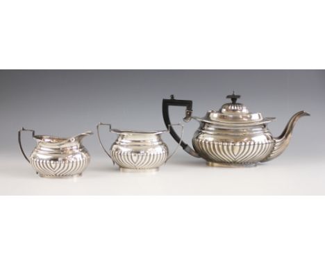 A silver tea service, W A Humphries Ltd, Birmingham 1976, comprising a teapot, milk jug and sugar bowl, the rope twist rim ab