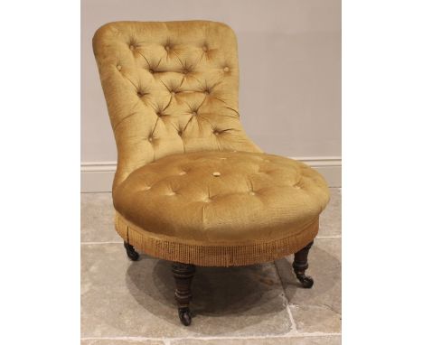 A Victorian walnut and upholstered low seat chair, in gold velour fabric, the button back and circular sprung seat upon turne