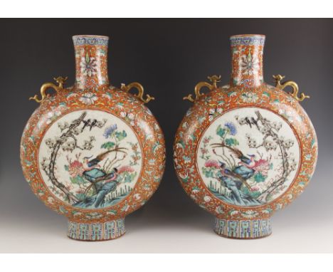 A large pair of Chinese porcelain moon flasks, 19th century (Xianfeng / Tongzhi), each centrally decorated in famille rose wi