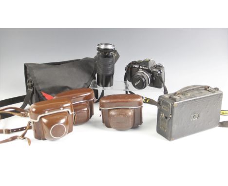 A selection of vintage camera equipment, to include a Nikon F-301 35mm single lens reflex camera with Nikkor 50mm 1:1.4 lens,