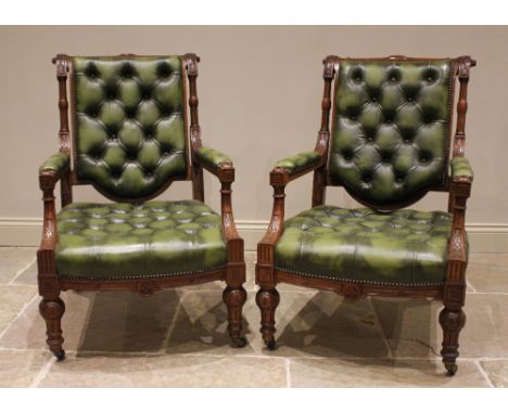 A pair of Victorian oak and olive green leather library chairs, in the manner of Holland &amp; Sons, the fluted top rail and 